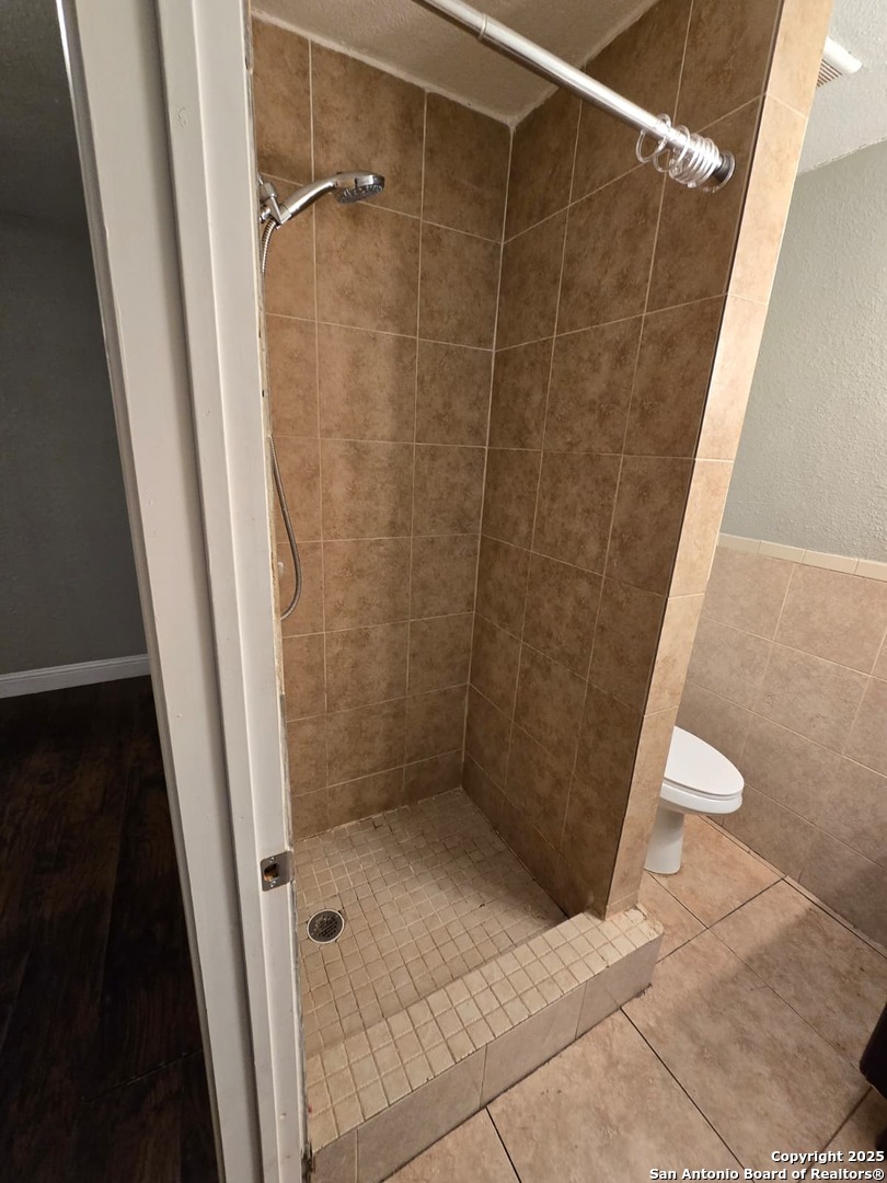 1718 Commercial, Unit B San Antonio, TX 78221 - Photo 7 of 13 a bathroom with a shower and a toilet