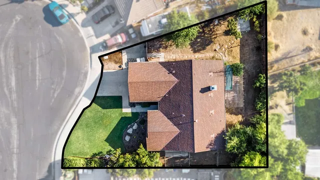 an aerial view of residential house with outdoor space and swimming pool