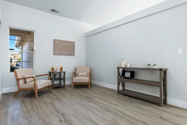 a bedroom with furniture and wooden floor