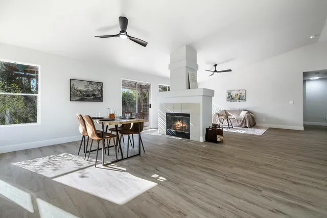 a living room with furniture a fireplace and a table