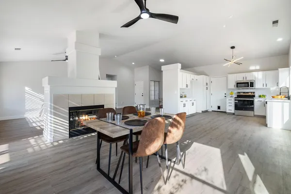 a view of a dining room with furniture and a fireplace