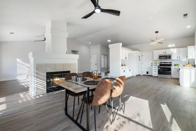 a view of a dining room with furniture and a fireplace