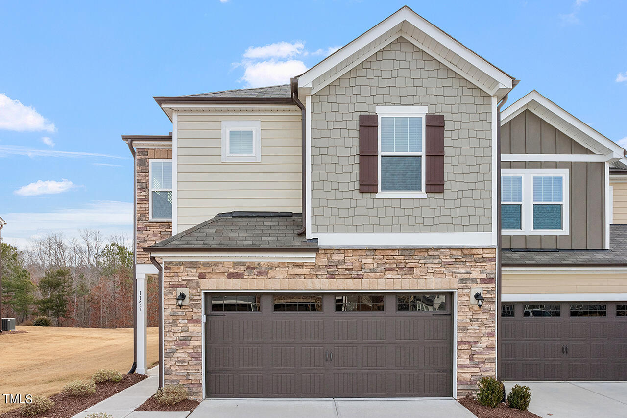 a view of house with backyard