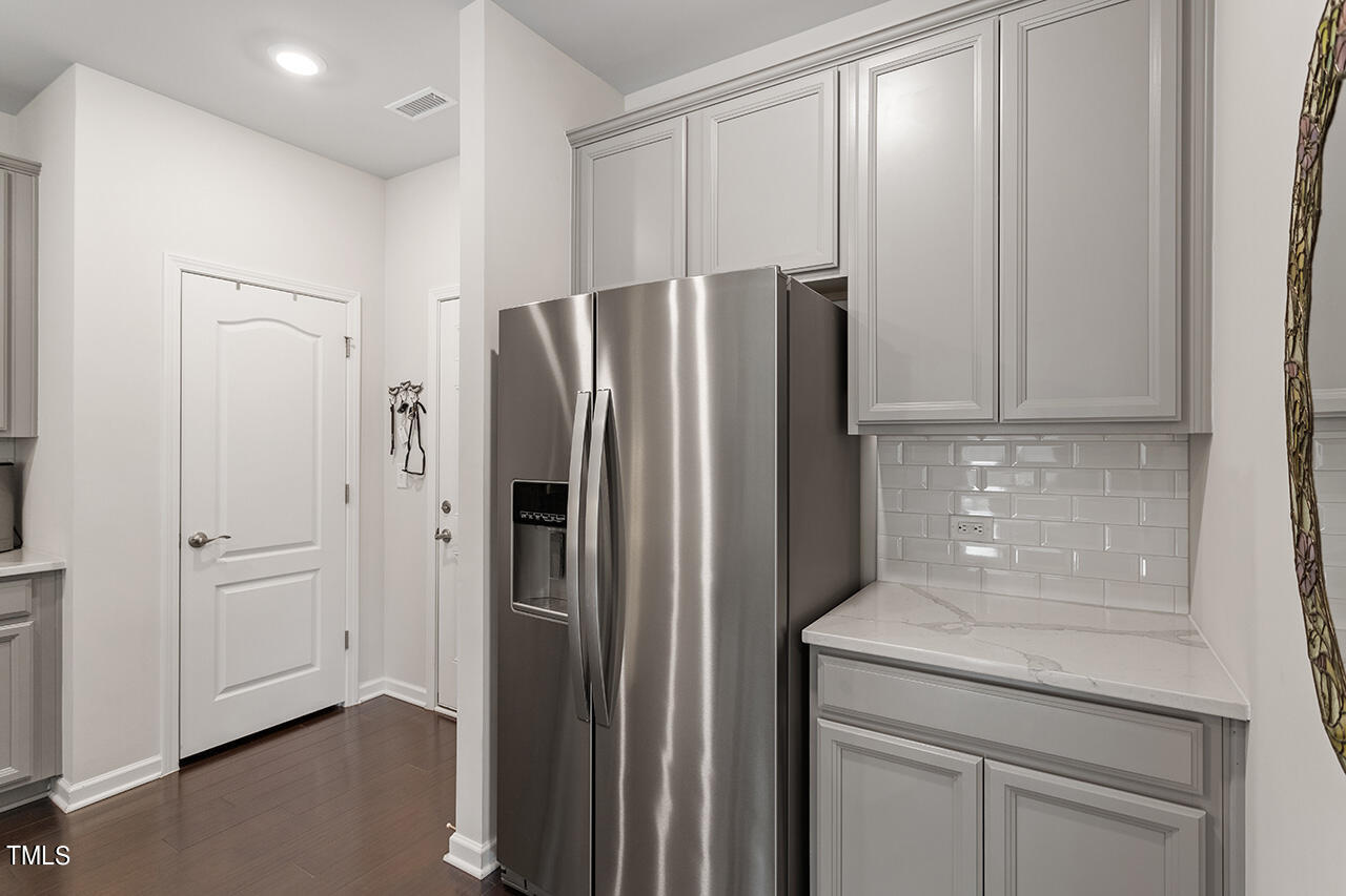 1157 Chestnut Bluff Apex, NC 27502 - Photo 12 of 42 a kitchen with metallic refrigerator freezer and a dishwasher