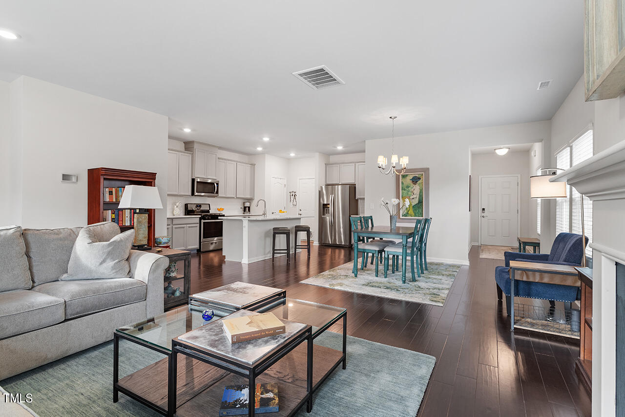 1157 Chestnut Bluff Apex, NC 27502 - Photo 13 of 42 a living room with furniture and kitchen view
