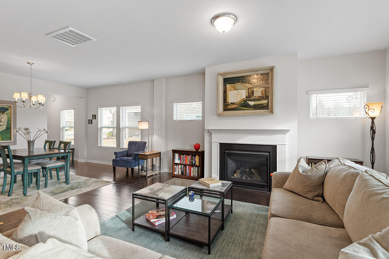 1157 Chestnut Bluff Apex, NC 27502 - Photo 14 of 42 a living room with furniture and a fireplace