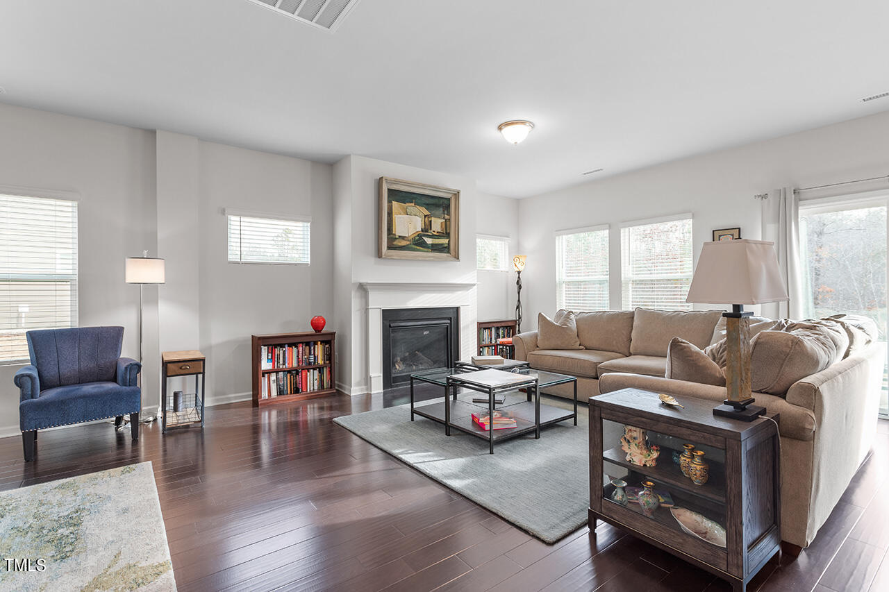 1157 Chestnut Bluff Apex, NC 27502 - Photo 15 of 42 a living room with furniture and a fireplace