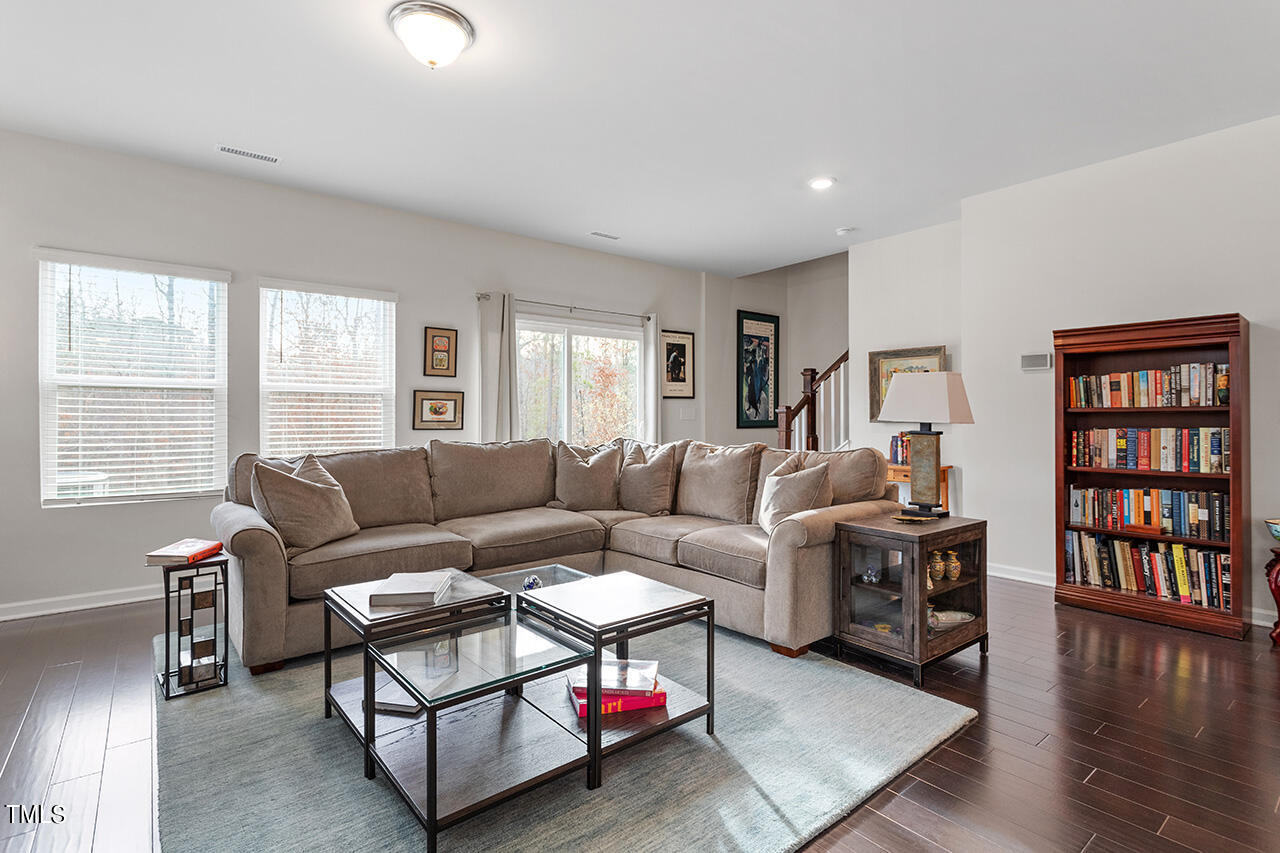 1157 Chestnut Bluff Apex, NC 27502 - Photo 16 of 42 a living room with furniture and a book shelf