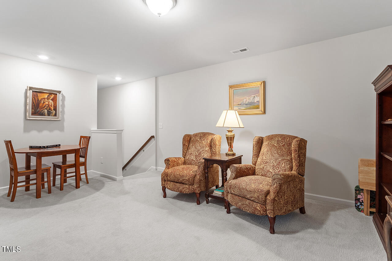 1157 Chestnut Bluff Apex, NC 27502 - Photo 19 of 42 a living room with furniture a couch and a bookshelf