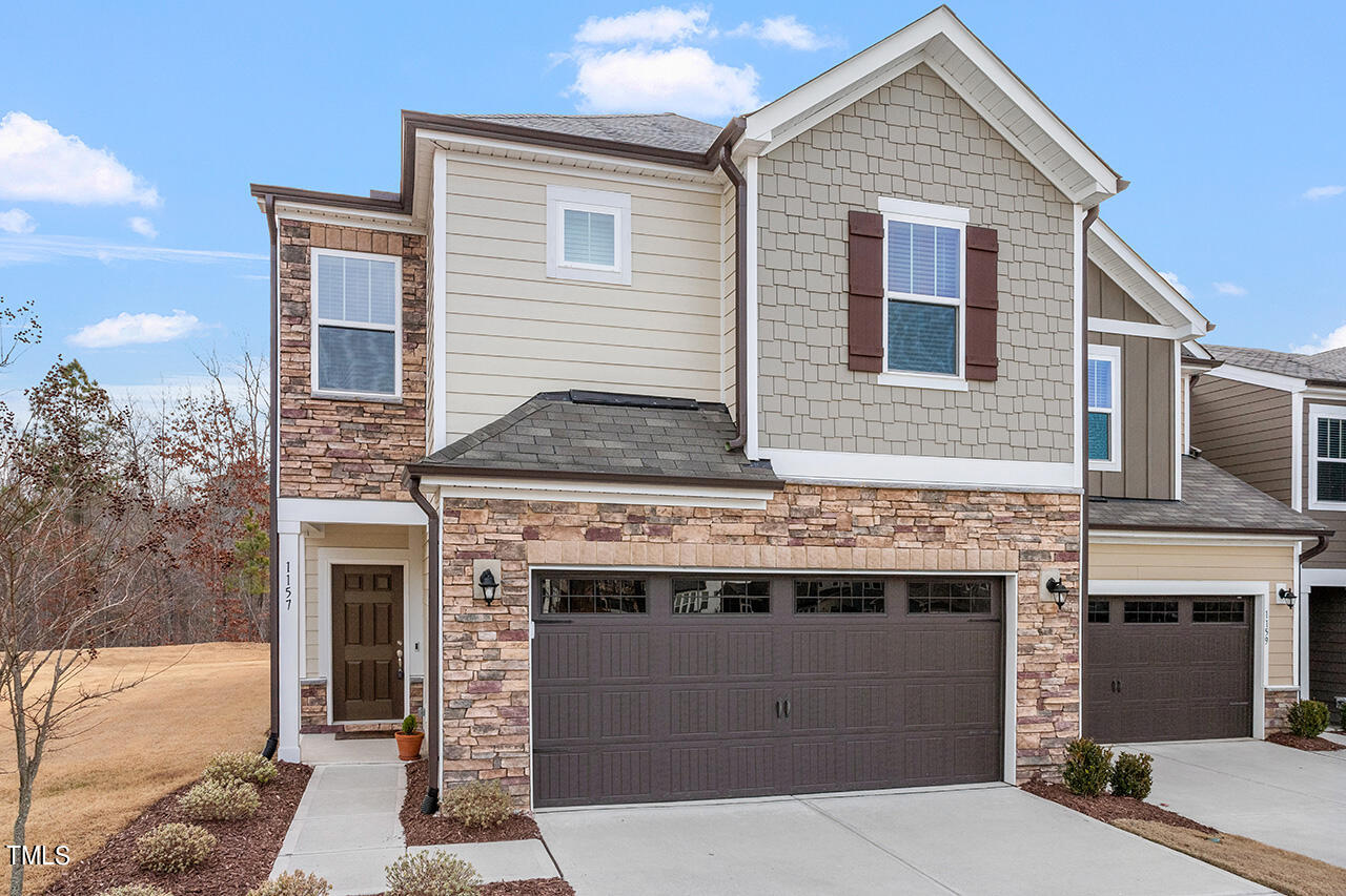 1157 Chestnut Bluff Apex, NC 27502 - Photo 2 of 42 a front view of a house with a garage