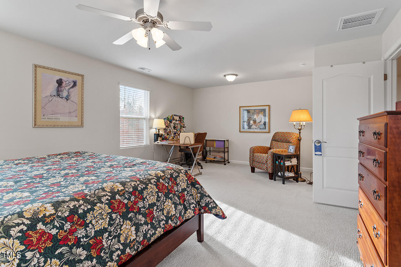 1157 Chestnut Bluff Apex, NC 27502 - Photo 22 of 42 a bed room with a bed and a chandelier