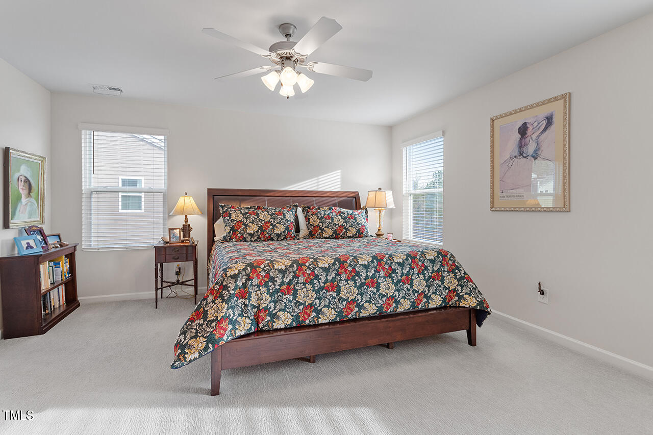 1157 Chestnut Bluff Apex, NC 27502 - Photo 23 of 42 a bedroom with a bed and a chandelier