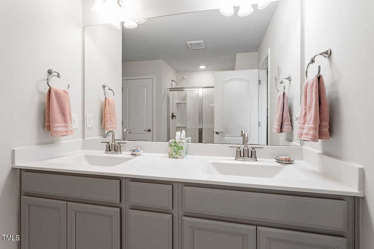 1157 Chestnut Bluff Apex, NC 27502 - Photo 24 of 42 a bathroom with a double vanity sink and a mirror