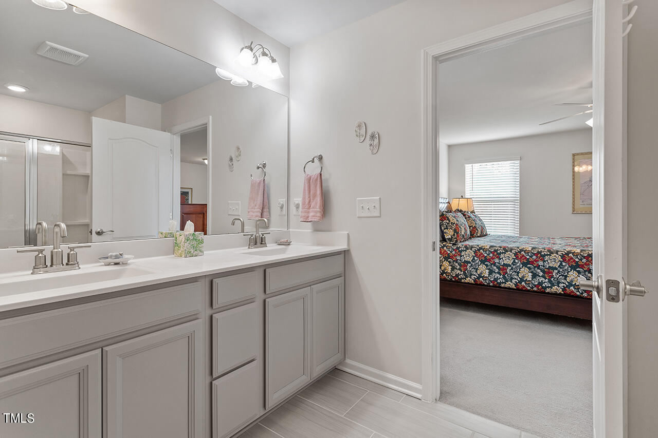 1157 Chestnut Bluff Apex, NC 27502 - Photo 26 of 42 a en suite bathroom with double sink and a mirror