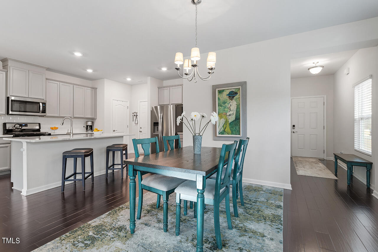 1157 Chestnut Bluff Apex, NC 27502 - Photo 6 of 42 a view of a dining room with furniture window and wooden floor