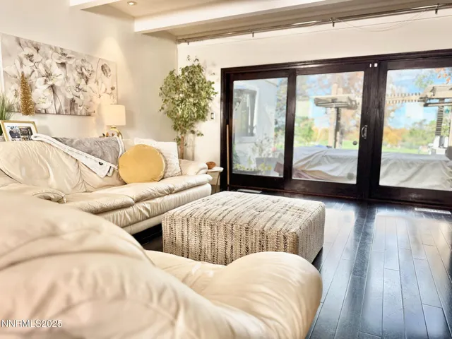 a bedroom with two large bed and a large window