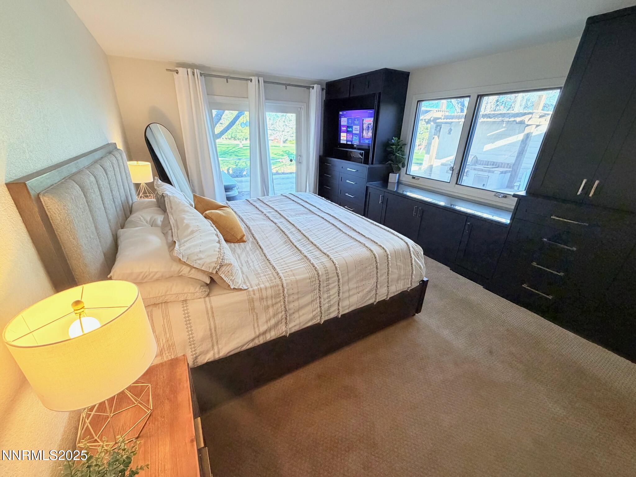 5012 Lakeridge Terrace East Reno, NV 89509 - Photo 15 of 49 a bedroom with a bed next to a window with wooden floor