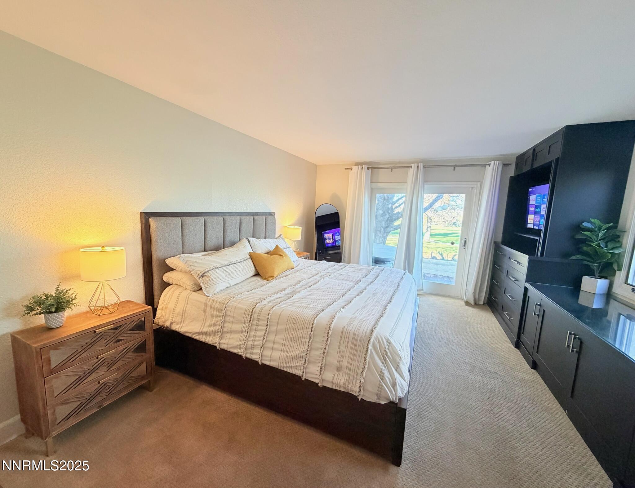 5012 Lakeridge Terrace East Reno, NV 89509 - Photo 16 of 49 a large bed sitting in a bedroom next to a window with a dresser