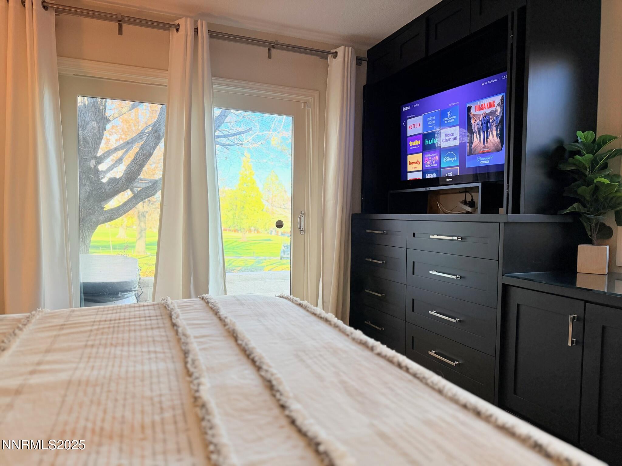 5012 Lakeridge Terrace East Reno, NV 89509 - Photo 19 of 49 a bedroom with a bed and a flat screen tv