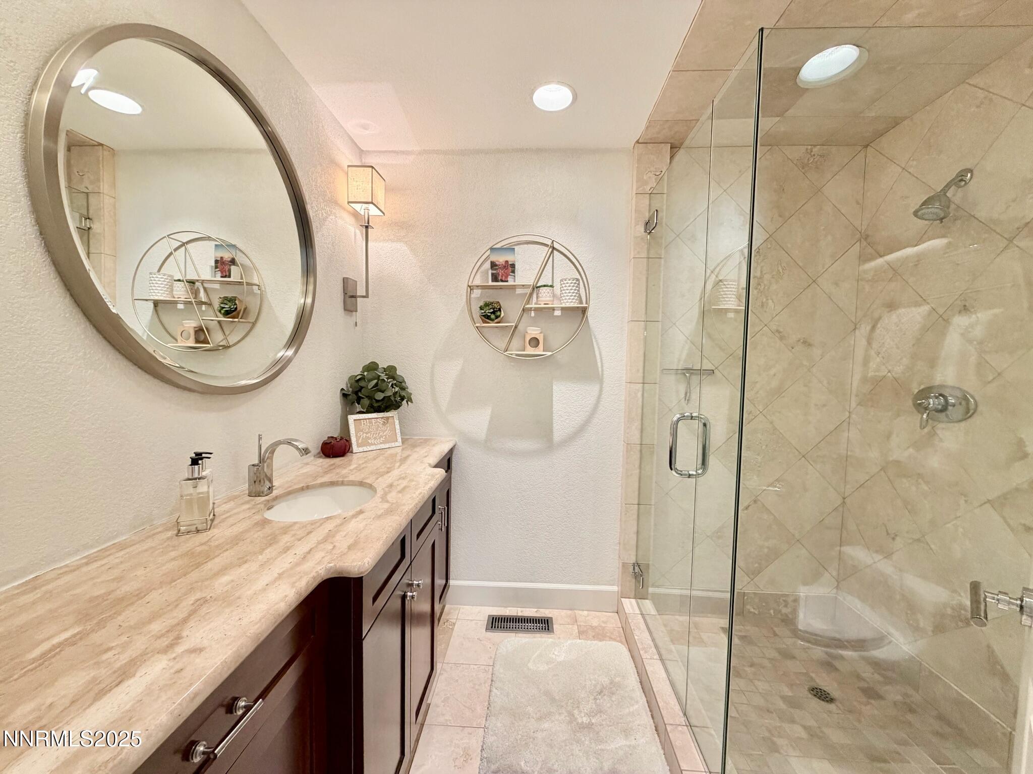 5012 Lakeridge Terrace East Reno, NV 89509 - Photo 31 of 49 a bathroom with a granite countertop sink a mirror and a shower