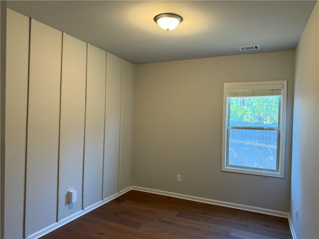 7811 Silk Tree Pointe Braselton, GA 30517 - Photo 15 of 20 an empty room with wooden floor and windows