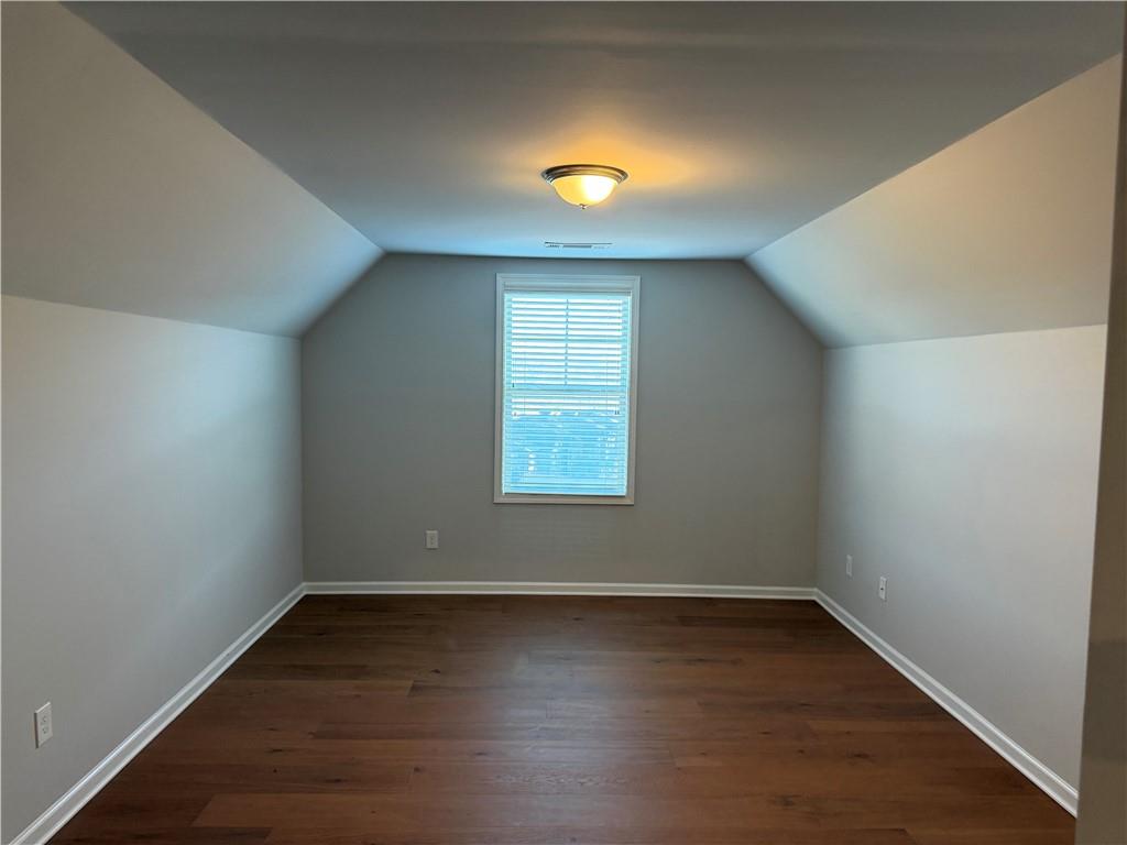 7811 Silk Tree Pointe Braselton, GA 30517 - Photo 16 of 20 an empty room with wooden floor and windows