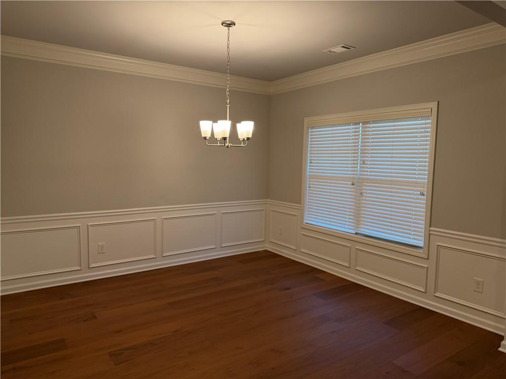 7811 Silk Tree Pointe Braselton, GA 30517 - Photo 3 of 20 an empty room with wooden floor and windows