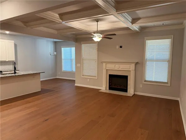 a view of a livingroom with a fireplace and window