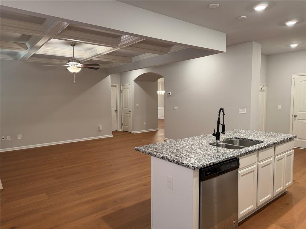 7811 Silk Tree Pointe Braselton, GA 30517 - Photo 8 of 20 a kitchen with a sink granite counter tops and a wooden floor
