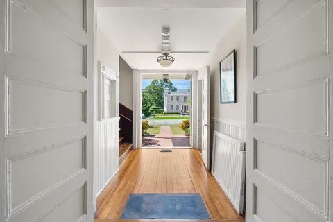 a view of a hallway view with wooden floor and furniture