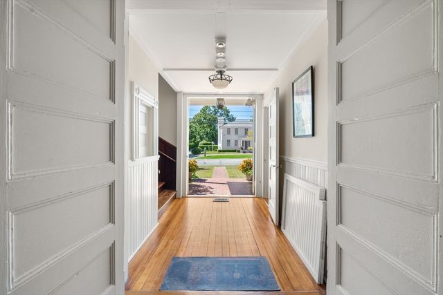a view of a hallway view with wooden floor and furniture