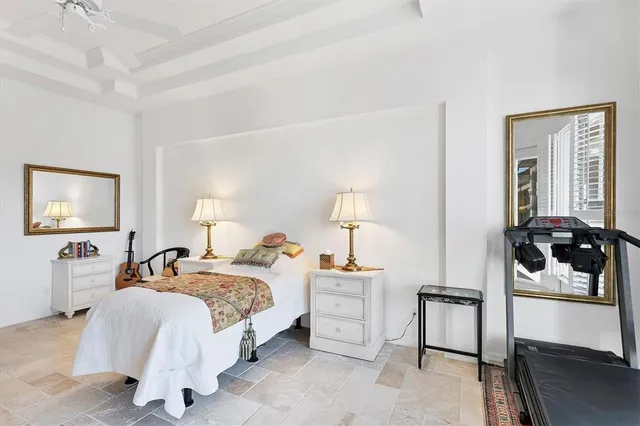 a front view of a house with a garden and trees