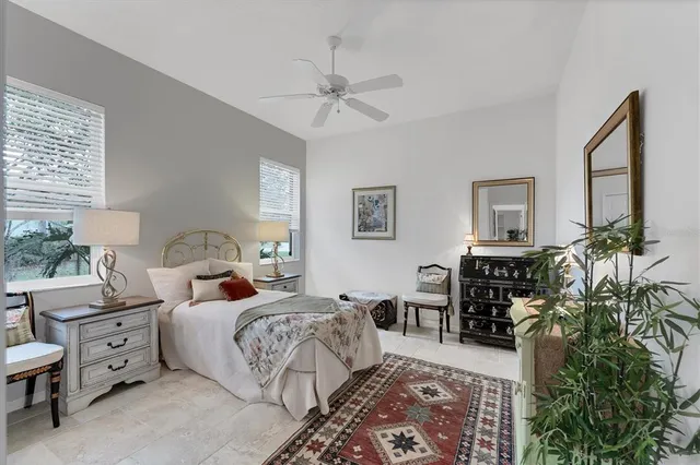a view of a patio with couches and table and chairs and potted plants