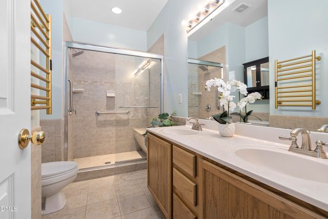 a view of a house with a small yard and wooden fence