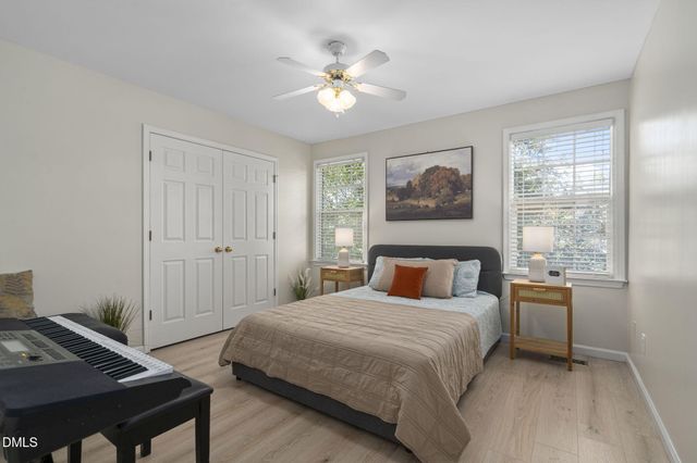 a bedroom with a large bed and a chandelier