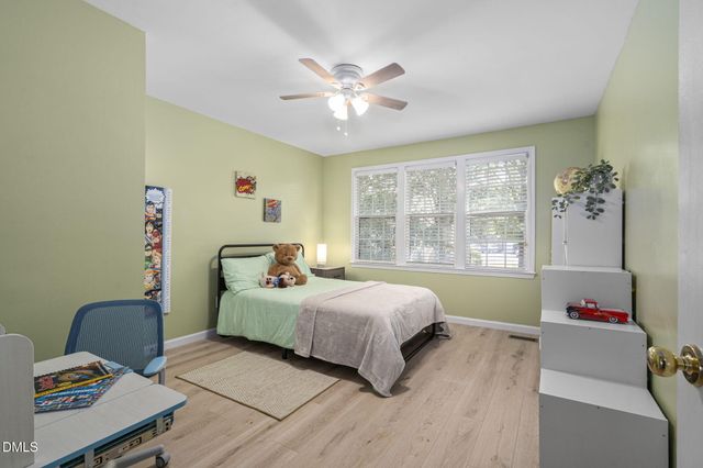 a bedroom with a bed and a table with chair