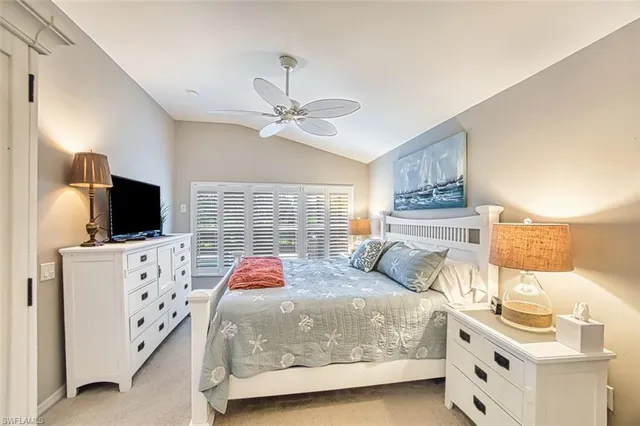 a bedroom with a bed and flat screen tv