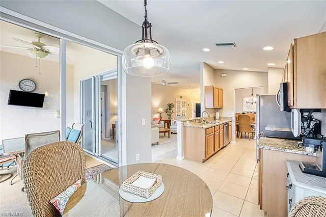 a kitchen with stainless steel appliances granite countertop a sink refrigerator and cabinets