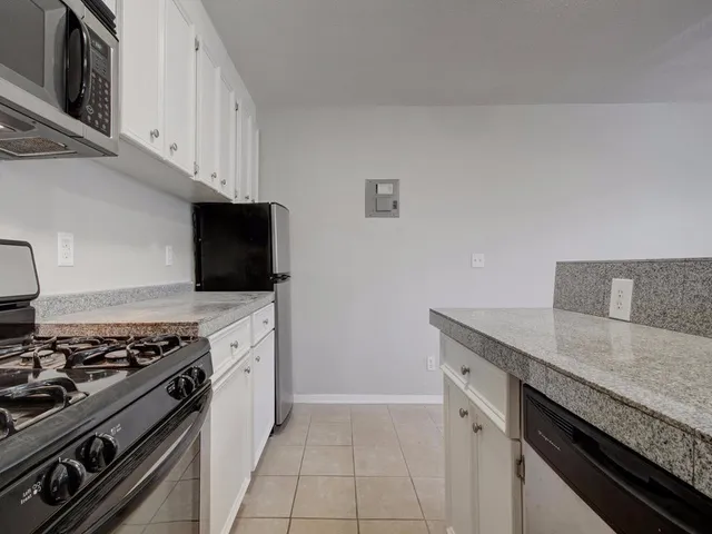 an empty room with a sink and dishwasher