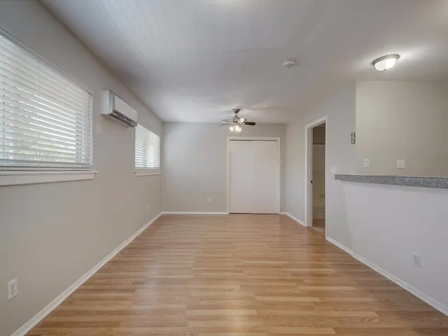 a view of an empty room with wooden floor