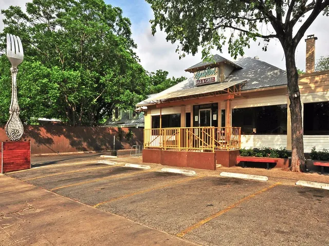a view of a brick building with a tree in front of it