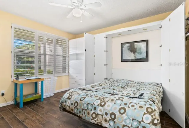 a bedroom with a large bed and a flat tv screen