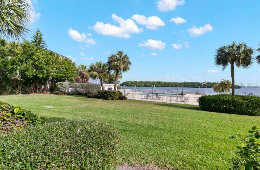 605 Sutton Place, Unit 102 Longboat Key, FL 34228 - Photo 19 of 29 a view of a garden