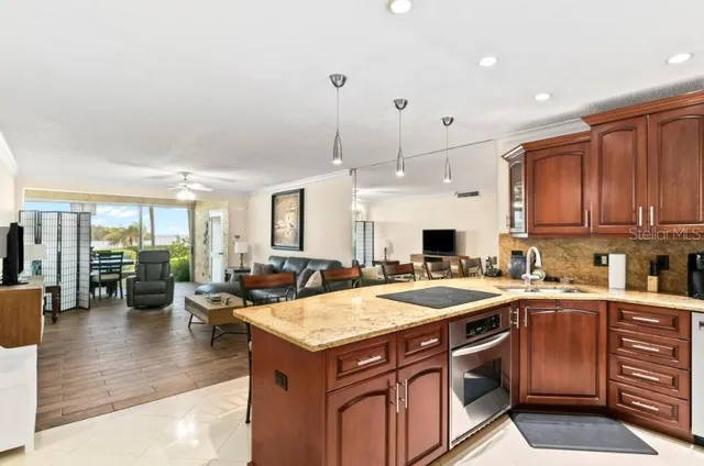 a kitchen with a stove a sink and a refrigerator