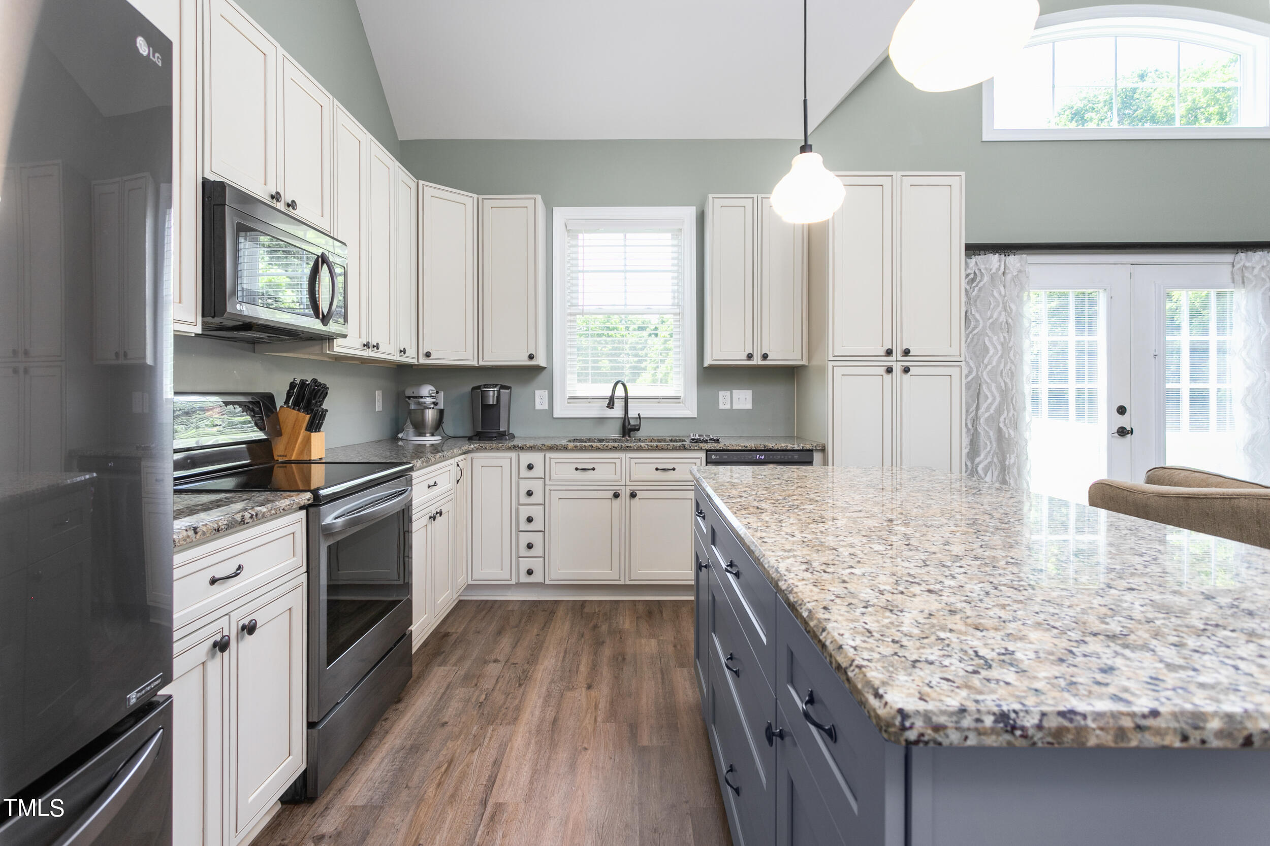 4455 Boyd Wright Road Burlington, NC 27215 - Photo 16 of 40 a kitchen with a stove sink and cabinets