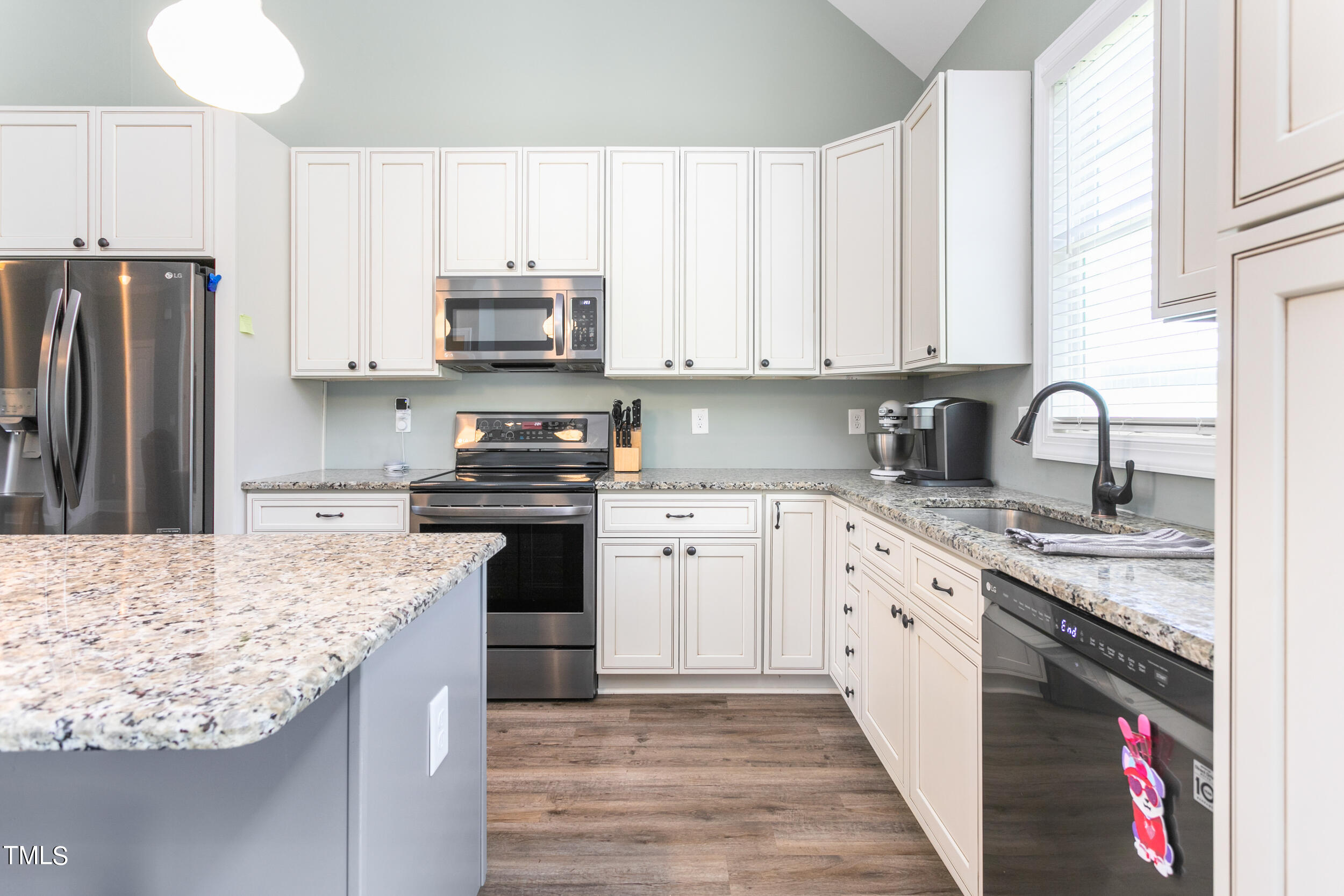 4455 Boyd Wright Road Burlington, NC 27215 - Photo 17 of 40 a kitchen with kitchen island granite countertop a sink stainless steel appliances and cabinets