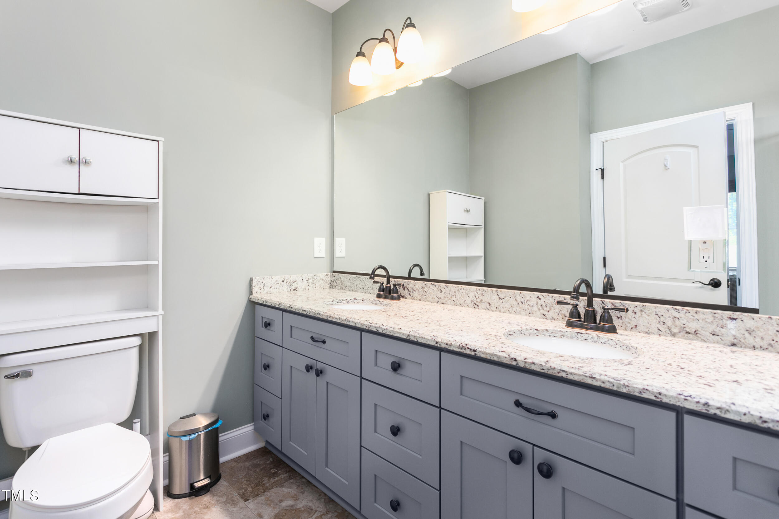 4455 Boyd Wright Road Burlington, NC 27215 - Photo 22 of 40 a bathroom with a granite countertop toilet sink and a mirror