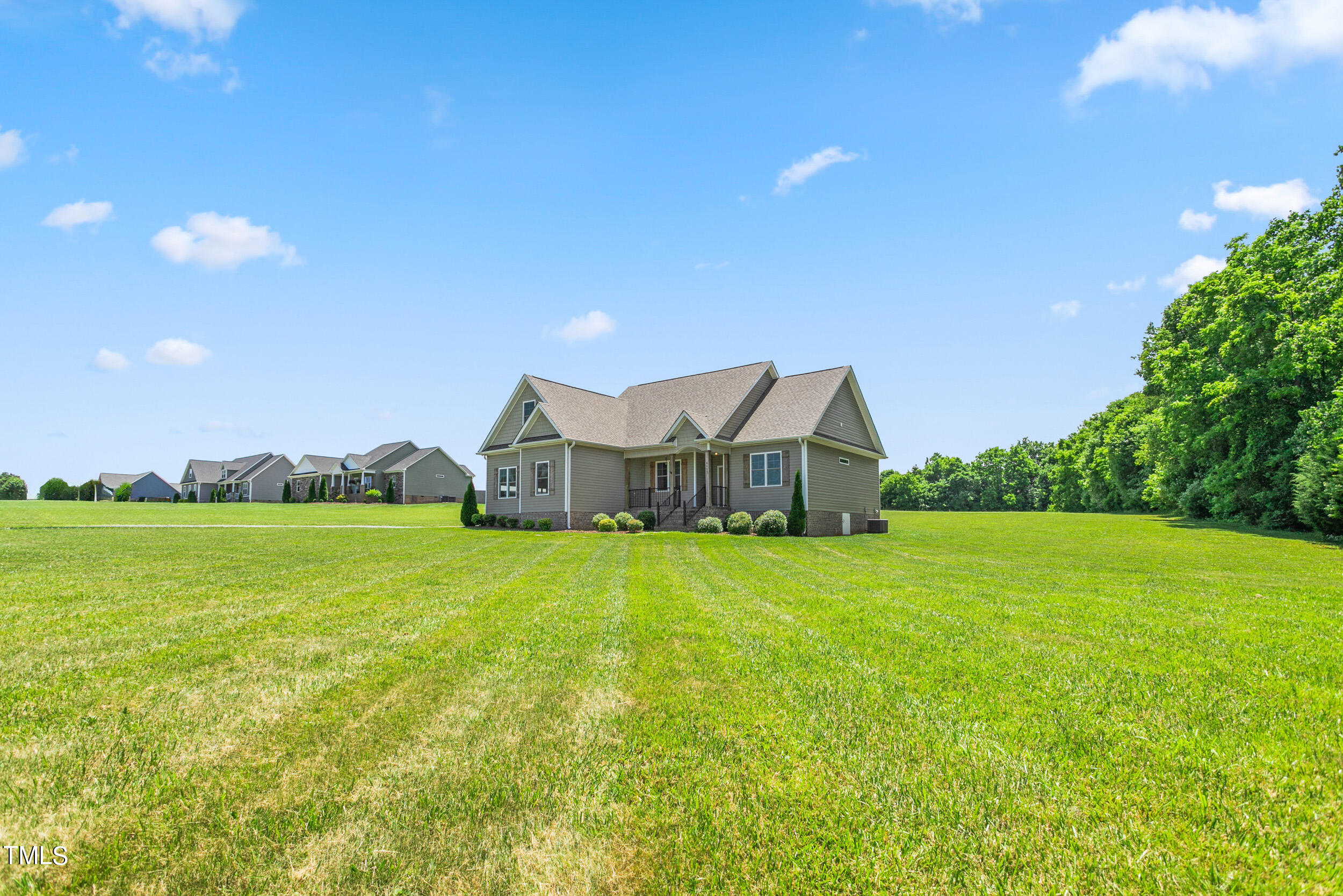 4455 Boyd Wright Road Burlington, NC 27215 - Photo 3 of 40 a view of a house with a big yard and a large tree