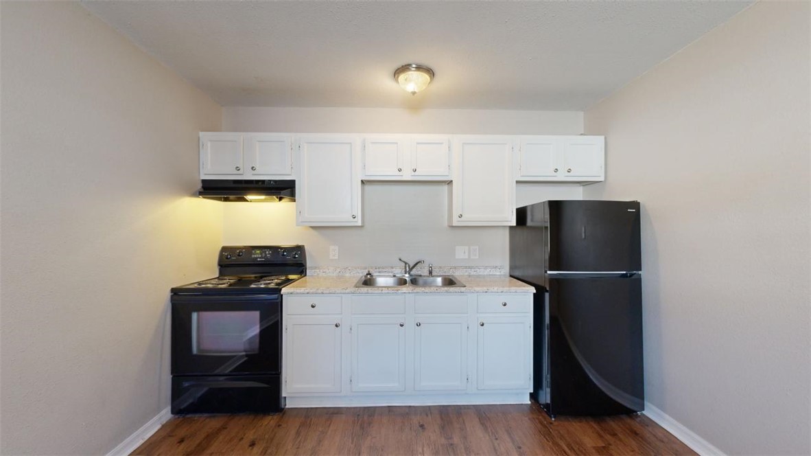 500 Foch Street, Unit 7 Bryan, TX 77801 - Photo 4 of 11 a kitchen with a sink appliances and cabinets