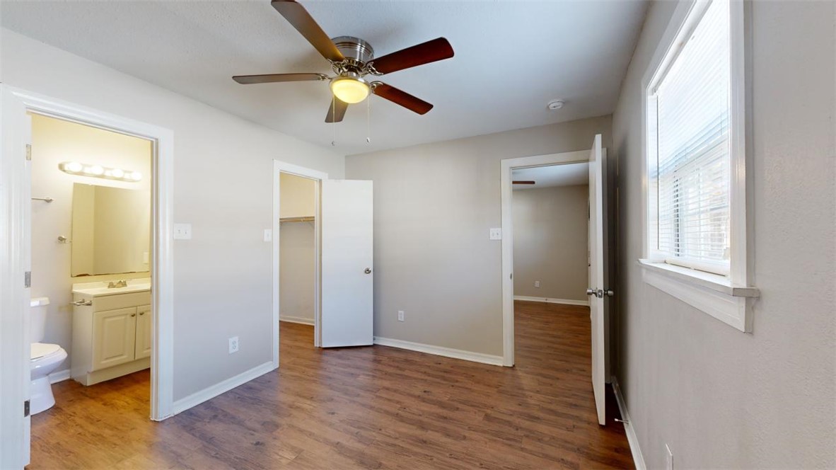 500 Foch Street, Unit 7 Bryan, TX 77801 - Photo 6 of 11 wooden floor in an empty room with a window